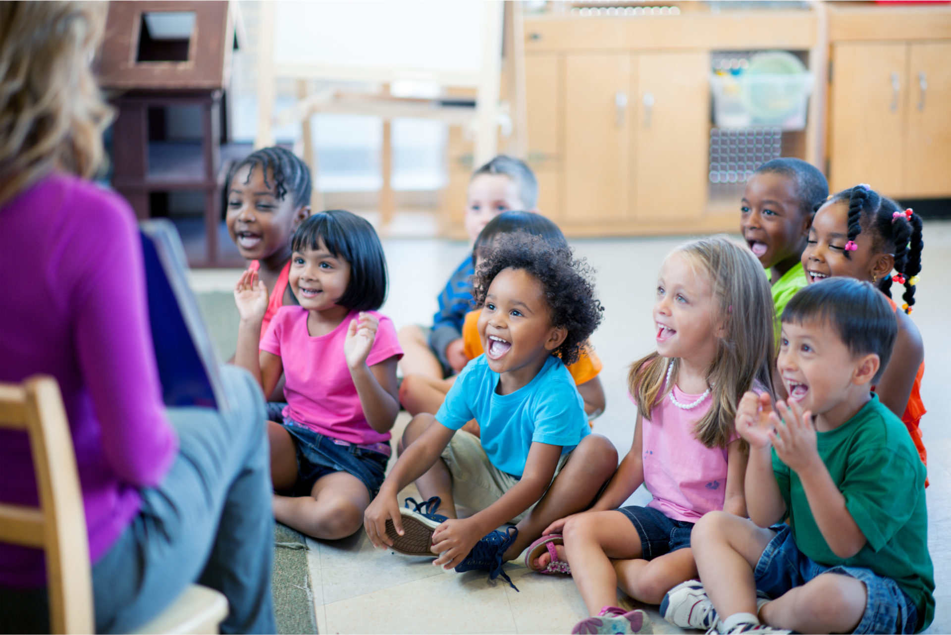 Happy children listening to storytime at school